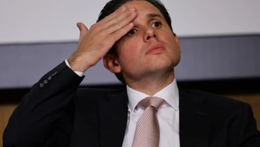 a man in a suit and tie is looking up at the sky