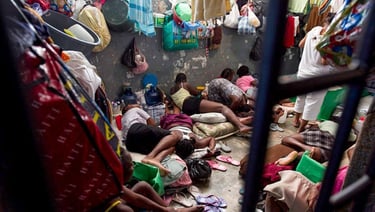 a group of people sitting on a bed in a room
