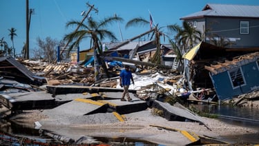 a man standing on a beach next to a body of water