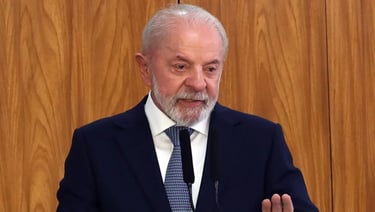 a man in a suit and tie is speaking into a microphone