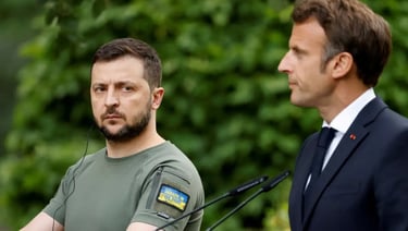 a man in a suit and tie standing in front of a microphone