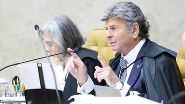 a man in a suit and tie is sitting at a table