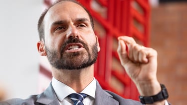 a man in a suit and tie is holding a microphone