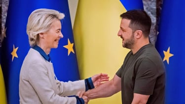 a man and woman shaking hands in front of flags