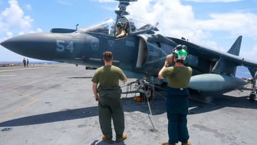 two men standing on a deck of a ship