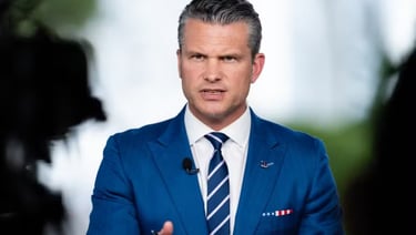 a man in a blue suit and tie with a microphone