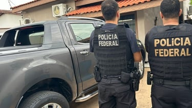 two police officers standing in front of a truck