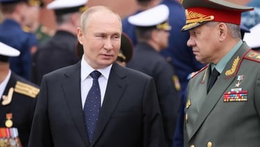 a man in a suit and tie is standing in front of a group of military