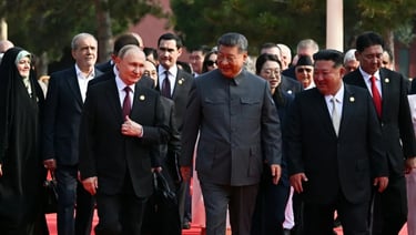 a group of men in suits and ties walking down a red carpet