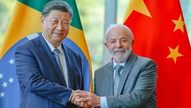 a man in a suit and tie standing next to a flag