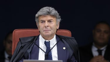 a man in a suit and tie sitting in a chair