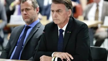 a man in a suit and tie sitting at a table