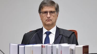 a man in a suit and tie is sitting at a desk
