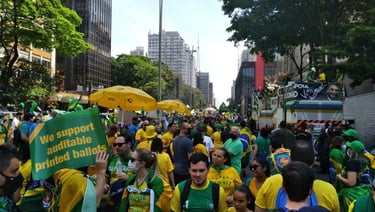 a group of people in green and yellow shirts and green umbrellas