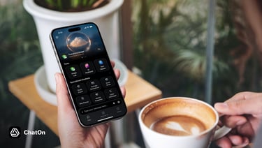 A person holding a smartphone showing the ChatOn AI app interface next to a cup of coffee.