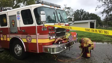 A Firefighter beside a fire engine, highlighting Austin Arthur’s public safety background 