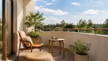 Sunlit small balcony with wooden chair, round table, woven cushion and plants inspired by Alvar Aalt