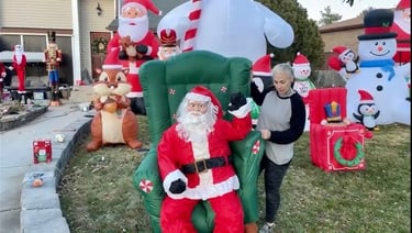 Woman setting up inflatable Christmas displays