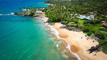 a beach with a sandy beach and a blue sky