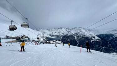 a ski lift in the mountains with people skiing