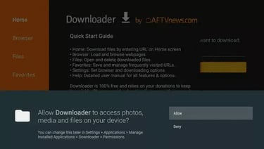 Screenshot of the Downloader app permission prompt on a smart TV to allow access to photos and media.