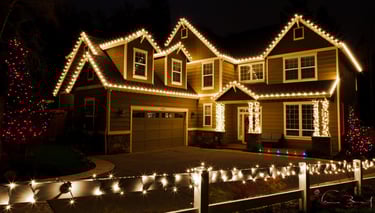 a house with christmas lights on a fence