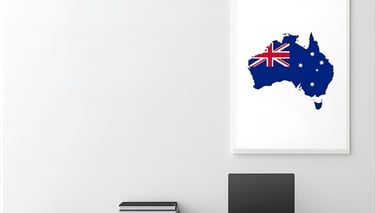 Desk with a laptop and map of Australia for learning English for relocation