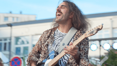 a man with long hair and a guitar