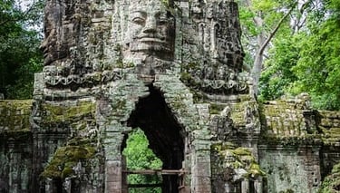 Angkor a man riding a motorcycle through a gated area