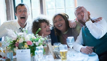 wedding guests sitting at a table havig fun