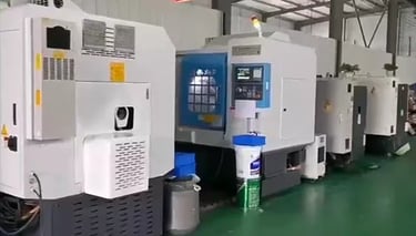 A row of industrial CNC milling machines in a modern factory production facility | RuiPros