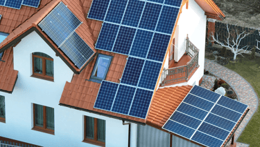 a man working on a roof with solar panels