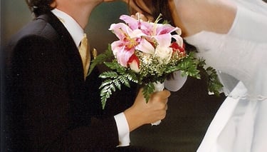 a bride and groom kissing in a wedding photo