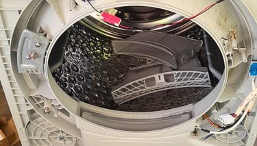 Front panel removed from LG heat pump dryer to inspect internal components due to burnt smell issue