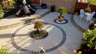 Fully paved multi-tier level garden with elevated raiesed patios and circles.