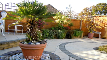 Fully paved multi-tier level garden with elevated raiesed patios and circles.