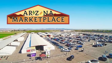 Aerial view of Arizona Marketplace in Yuma featuring outdoor flea market stalls and a large parking lot.