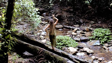 a woman with dreadlocks in the rainforest