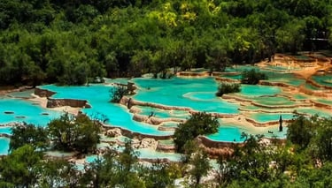 Turquoise lakes of Jiuzhaigou, snow-capped peaks of Huanglong, and a giant panda in a bamboo forest.