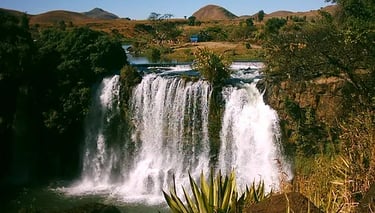 Lake Itasy with greenery, volcanic crater, and horseback rider in Madagascar.