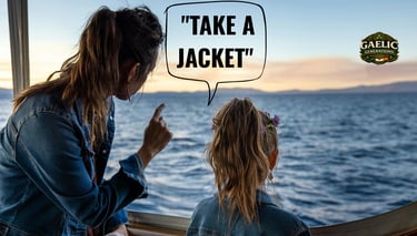 A mother and daughter in denim jackets looking over the ocean at sunset with a Take a Jacket caption.