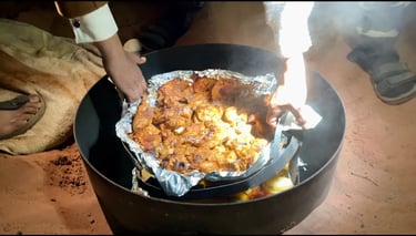 a person cooking Zarb meal underground in the desert