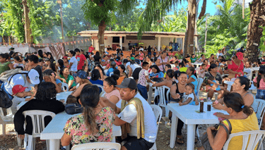 A large crowd of people gathering at the Mothers Day Celebration organized by Roger Bardales