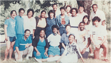 a group of people standing around a tree