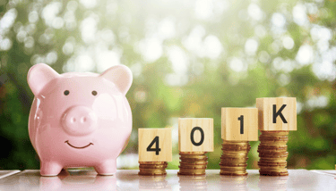 piggy bank and 401k blocks on gold coins