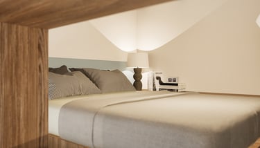 Chambre sur la mezzanine, vue zoomer sur la tête de lit et la lampe de chevet