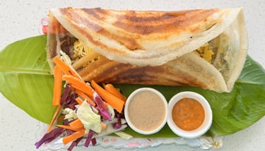Masala dosa filled with spiced potato, served fresh at Aroha Dosas