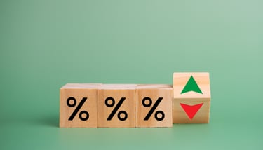 interest rate symbols with a red arrow going down for rate cuts