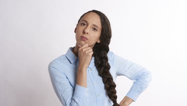 woman thinking thoroughly and wondering if gold ira is a scam