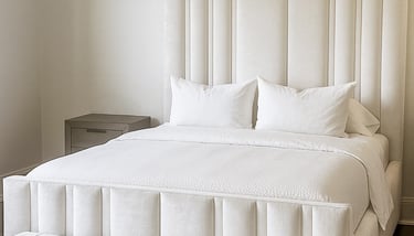 Bedroom with vertical upholstered wall panels in a soft neutral tone by Solo Home Decor